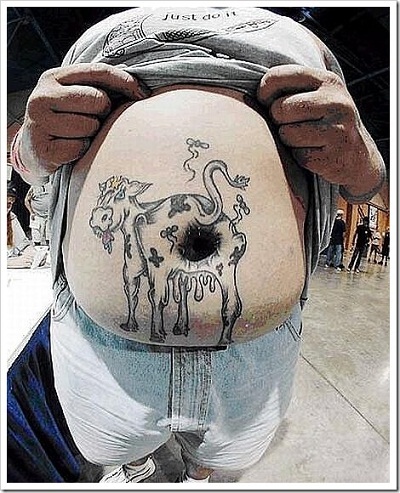 a cow tatoo on a very large stomach