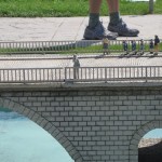 large feet walking next to tiny people